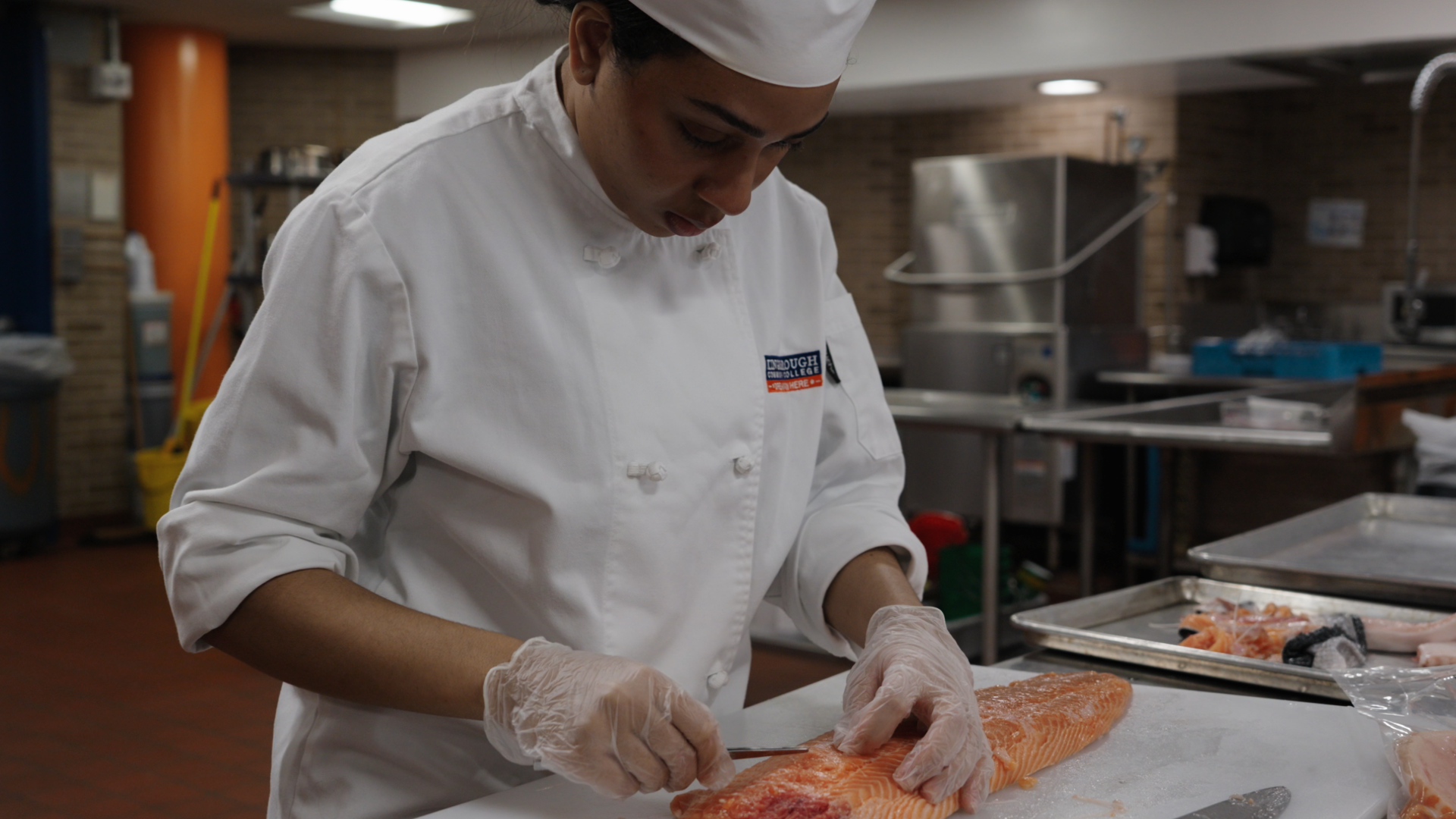 student prepping salmon