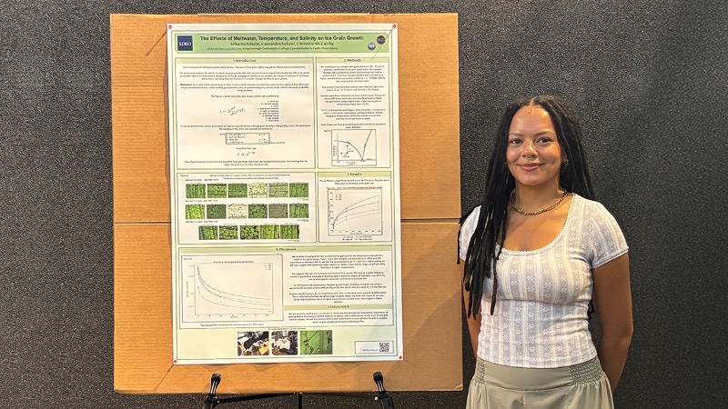 Berkmans with her poster, titled "The Effects of Meltwater, Temperature, and Salinity on Ice Growth.